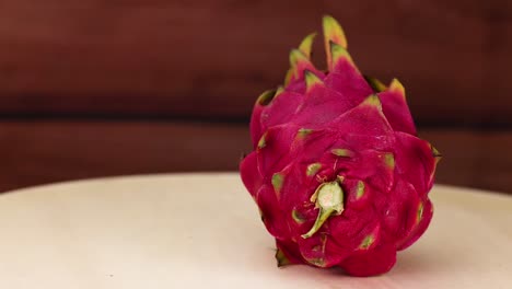 dragon fruit rotates on a wooden table