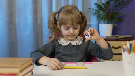 Child-girl-doing-school-homework-teach-alphabet-letters-with-teacher-at-home,-video-call-by-webcam