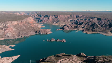stunning aerial view of the turquoise waters and rugged rock formations of the atuel canyon in san rafael, mendoza, argentina.