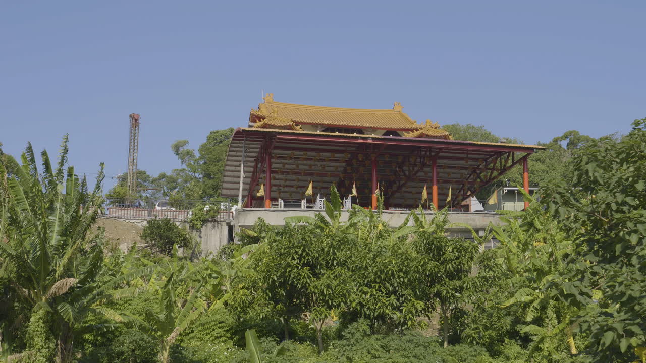 Hillside Temple in Rural Taiwan with Prayer Flags Blowing in Wind