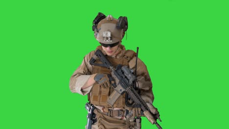 soldier shoots aming and shooting with rifle on a green screen, chroma key