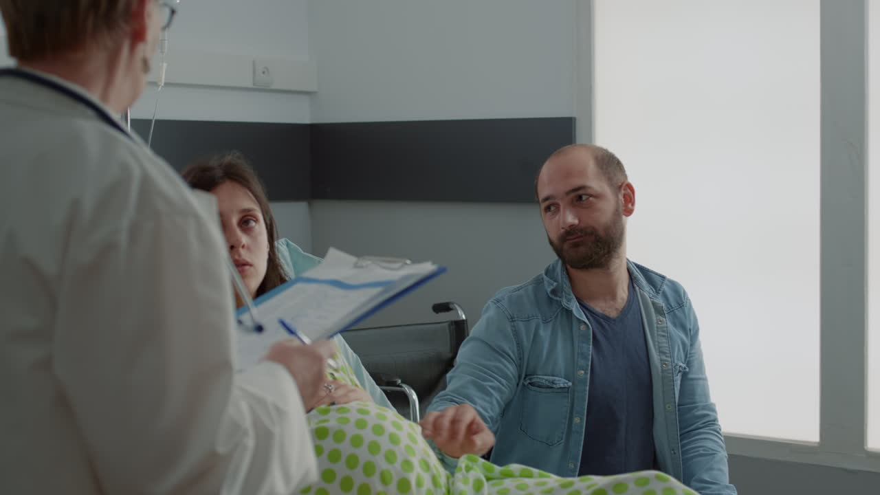 Maternity doctor giving advice to pregnant woman and husband