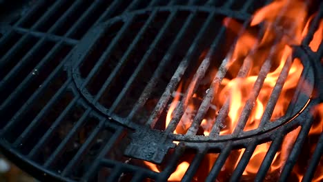 outdoor grill bars closeup showing flames and smoke from burning charcoal with copy space