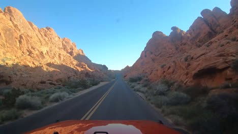 Driving-a-red-vehicle-in-the-Valley-of-Fire-Nevada-State-Park-on-Mouse's-Tank-Road