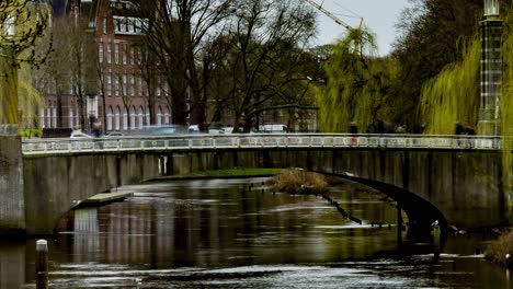 Close-Time-lapse-of-people-and-cars-crossing-bridge-over-river-in-Den-Bosch,-the-Netherlands