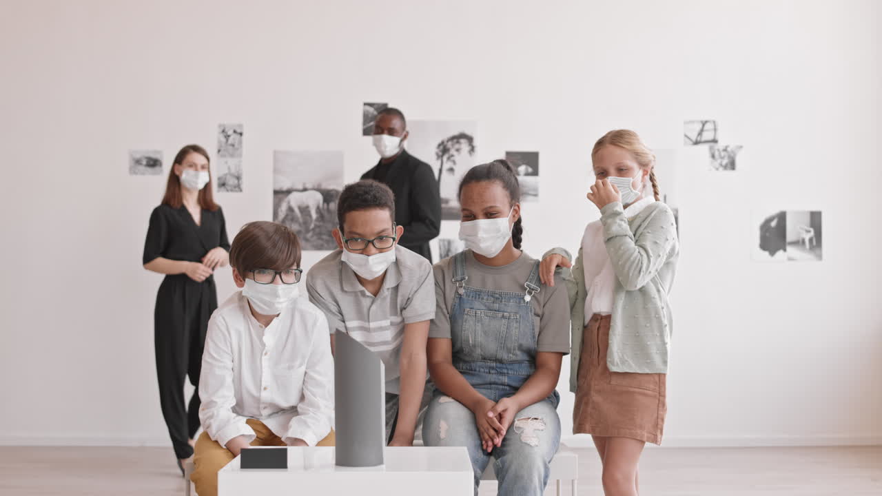 Adults and Kids Looking at Art Object