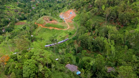 captivating aerial drone footage of a train crossing the iconic railway bridge in ella, sri lanka.