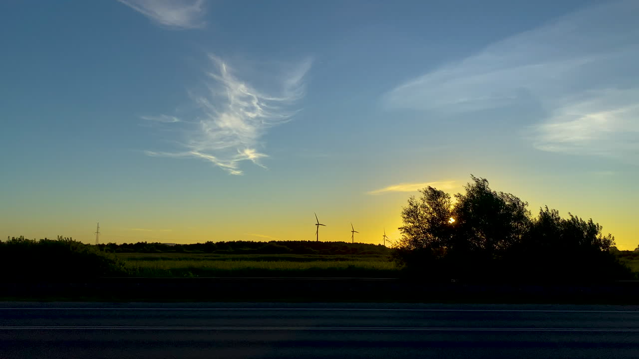 Wind Turbines Generating Power At The Wind Farm During A Beautiful Sunrise In The Countryside Of Puck, Poland. - wide shot - slow motion