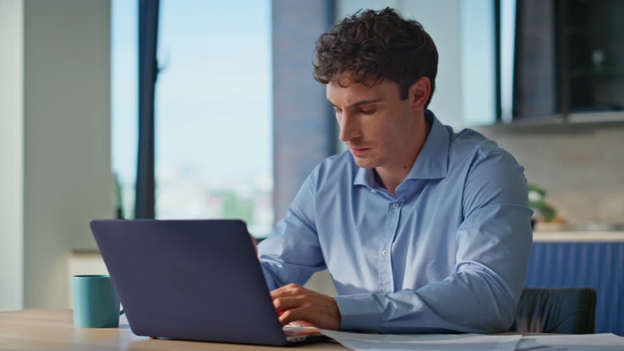 Man working laptop kitchen home closeup. Professional worker pondering ideas