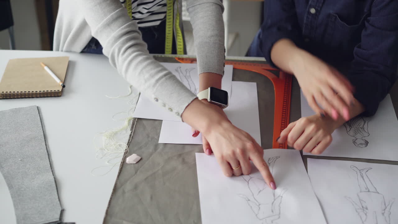 Fashion Designers Working on Sketches