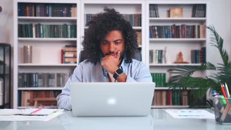 focused arabian man thinking makes puzzled expression face working with laptop