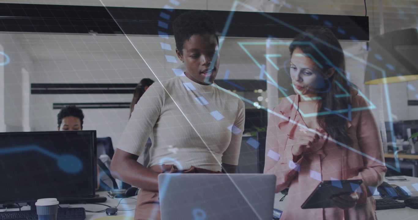 Two Businesswomen Collaborating on a Project in a Modern Office