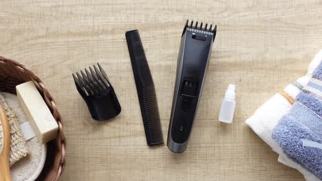 hair trimmer and grooming kit on a wooden table