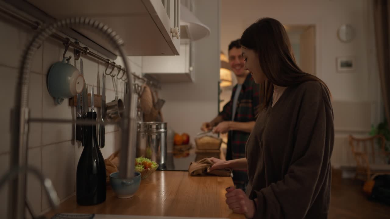 A couple preparing food in the kitchen