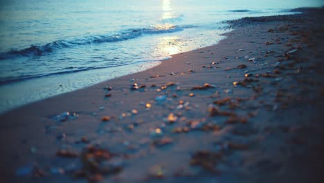 pebbles, sand and ocean waves with vintage lens