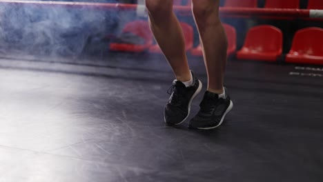 Close-up-of-young-female-s-legs---boxer-jumping-on-the-skipping-rope-on-ring