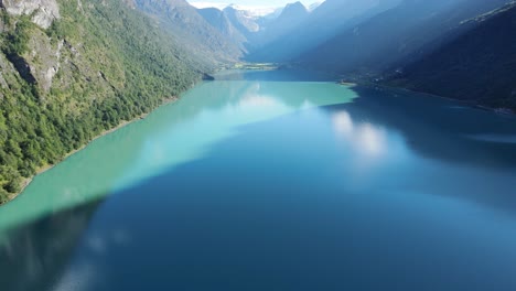 moutains casting a shadow over beautiful green water odevatnet glacier lake