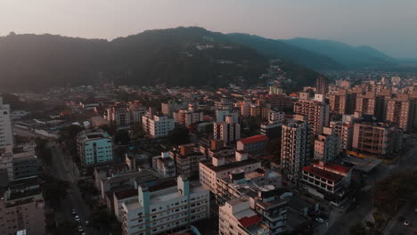 aerial view of an urban cityscape with mountains and buildings