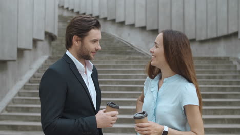 Cheerful-coworkers-talking-in-city.-Woman-and-man-having-meeting-after-work