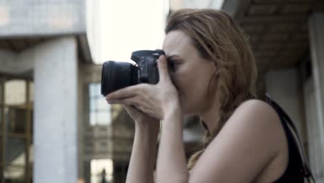 woman taking photos in city