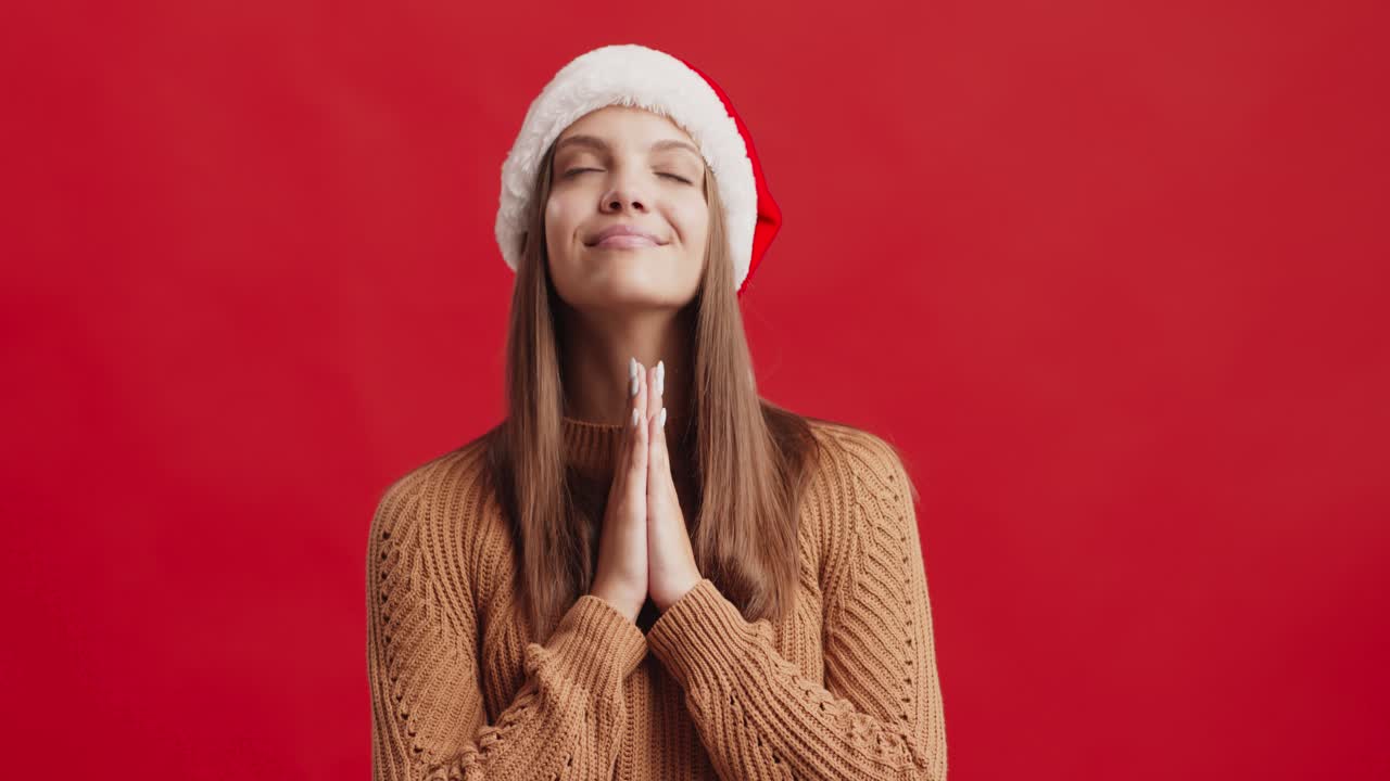 Woman in a Santa Hat Praying