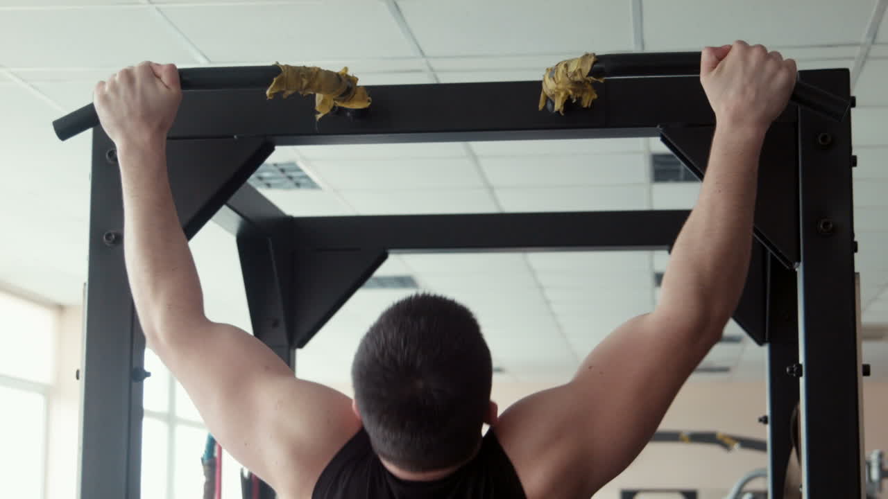 Male Bodybuilder Pulling Up in a Gym (Stock Footage)