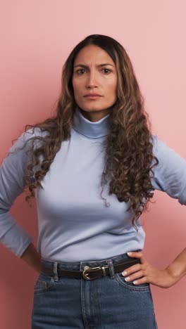 upset woman with arms crossed standing disappointed. vertical footage