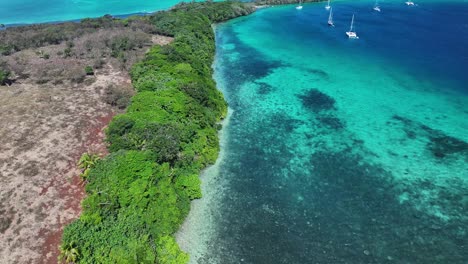 serene island of vava'u with boats sailing during daytime in tonga. aerial, wide shot