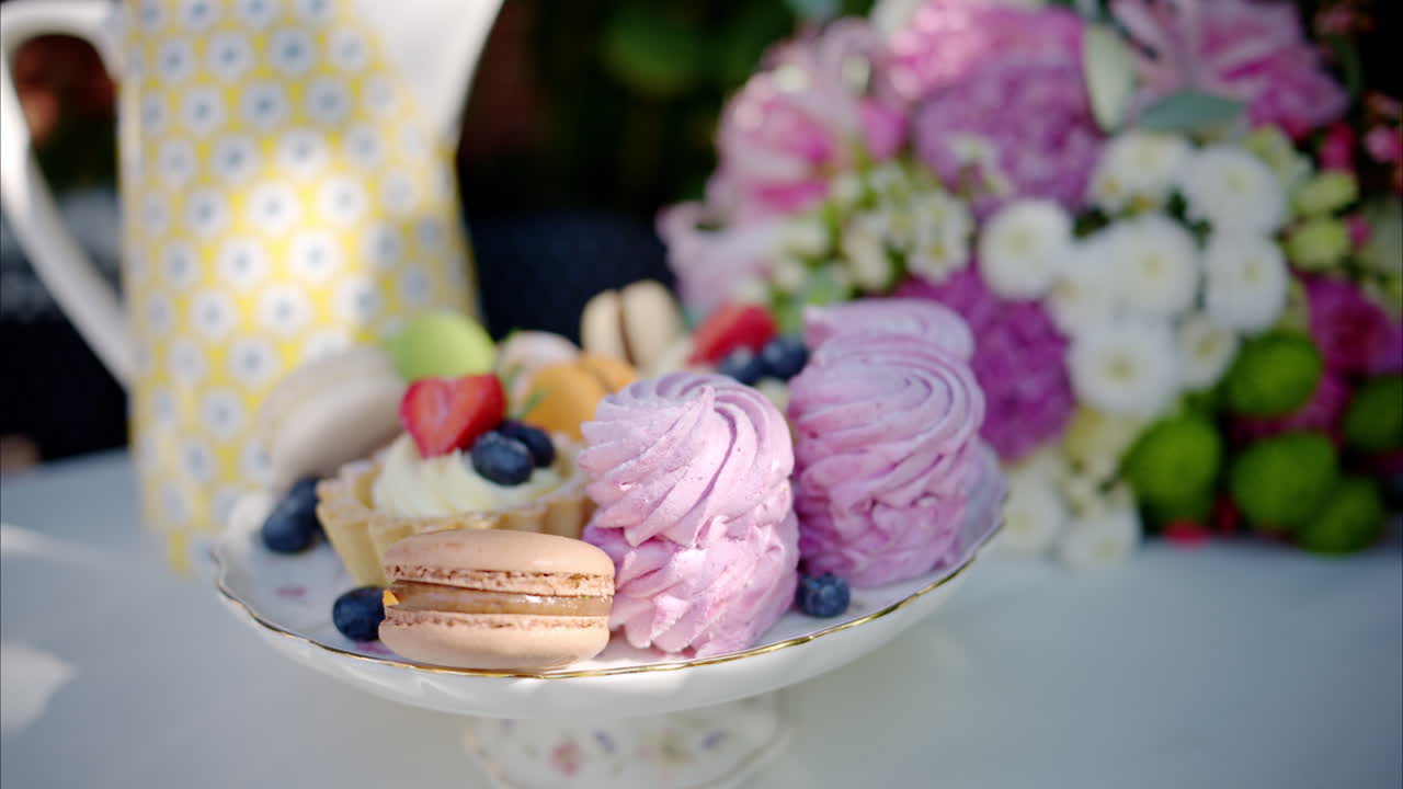 Composition with flowers, macaroons sweets desert and coffee and tea