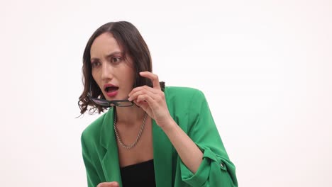 Young woman with a surprised expression adjusting or removing her glasses