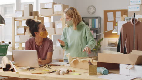 two women packing orders in a home office