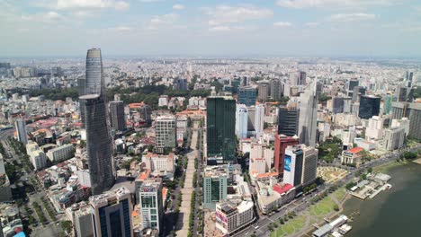 aerial zoom out of district 1 cityscape and nguyen hue walking street in saigon vietnam on a sunny day