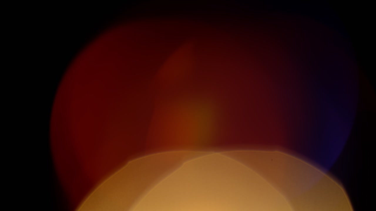 Multicolored light leaks 4k footage on black background. Stylizing video, transitions. Bokeh effect