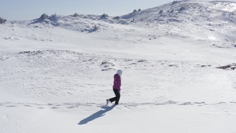 Walking-up-in-mountains-alone-expedition---Young-woman-confident-hiking-on-mountains-covered-with-snow