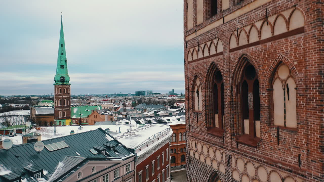 Aerial shot of drone flying above the St. Peter Church in Riga at winter