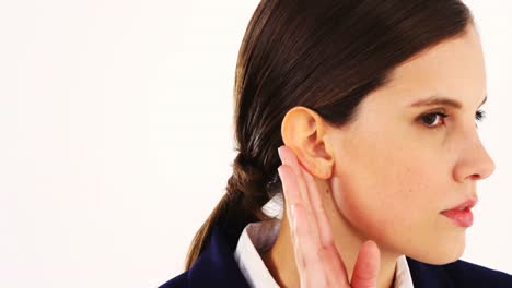 pretty businesswoman secretly listening to something