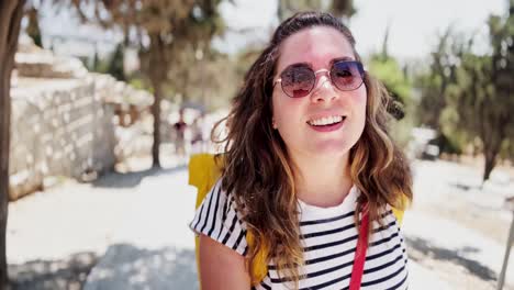 female vlogger talking to camera at a historic site, athens, greece