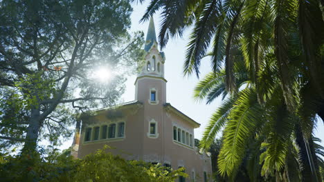 pink house in park with palm trees