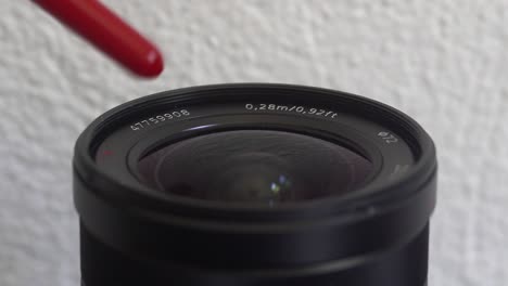 clearing dust from lens with a rubber hand air blower, 4k