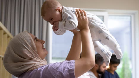 clcose-up view of islamic woman and baby in the living room.