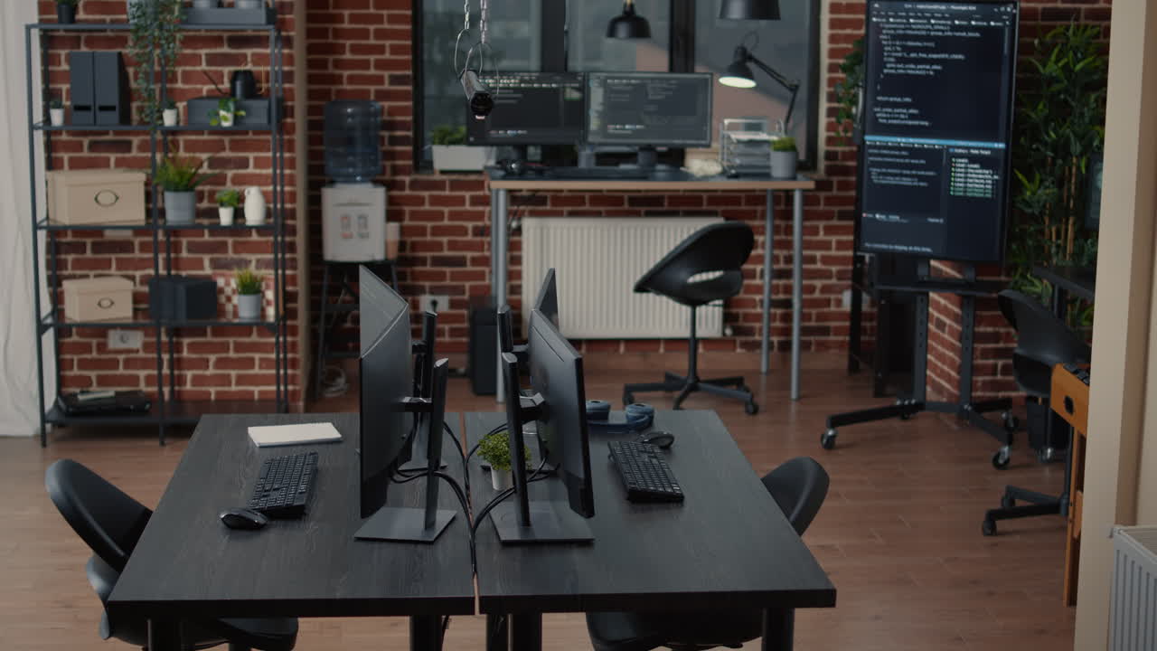 Computer screens on desk in empty software it agency office and computers in background