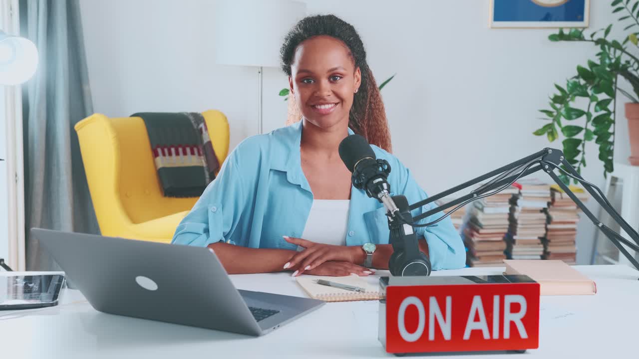 Young smiling african american woman business coach sits at desk in home office