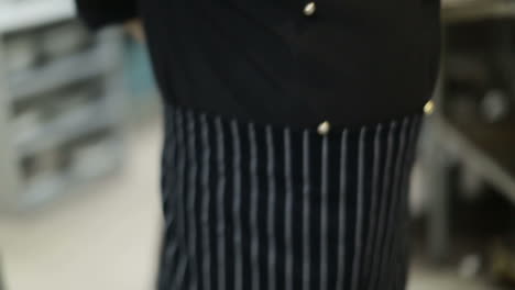 chef prepares for work. male cook prepares to work in the kitchen of the restaurant