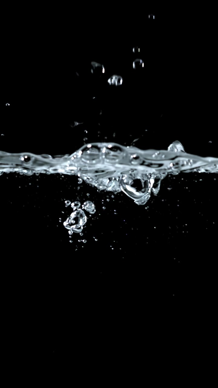Clear Water Splashing and Bubbling on a Black Background