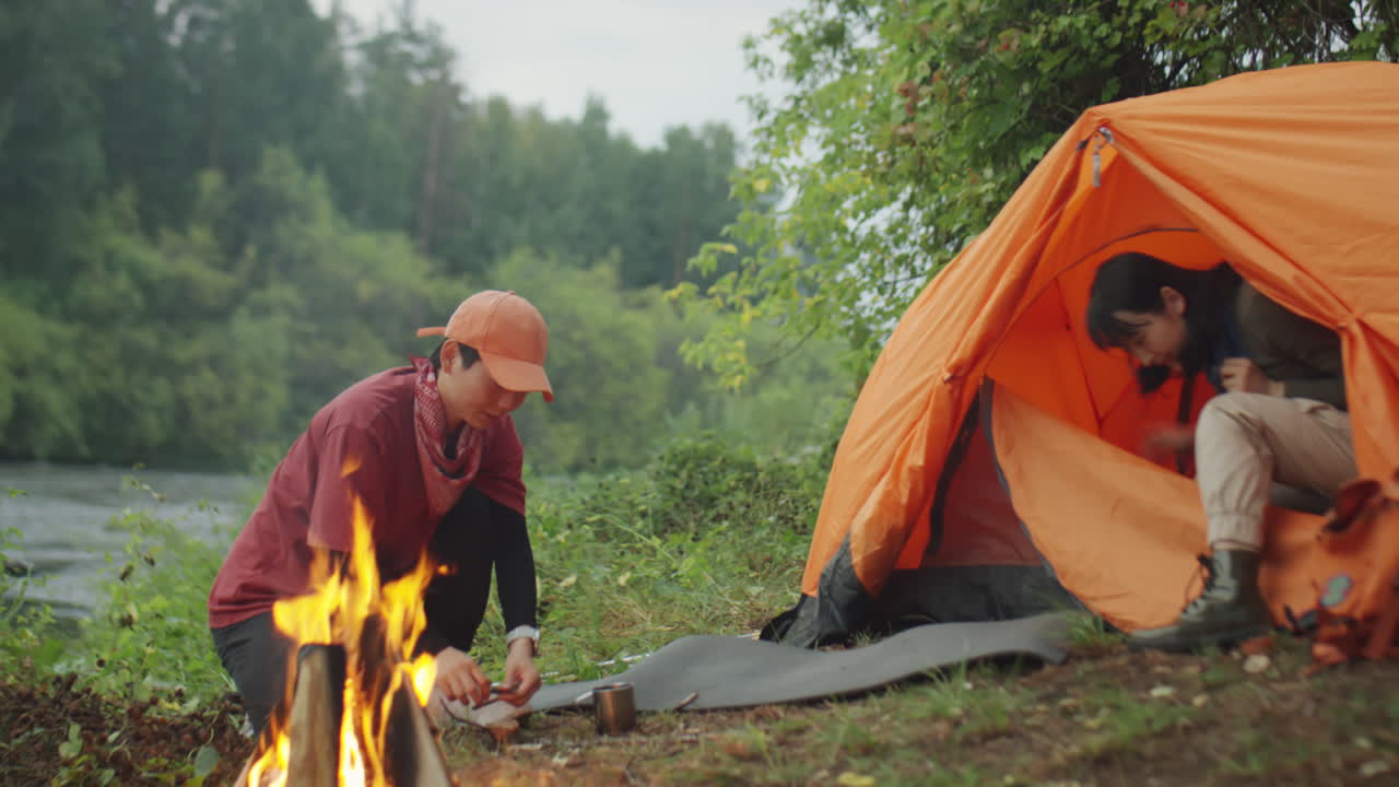 Female Tourists Keeping Fire at Campsite