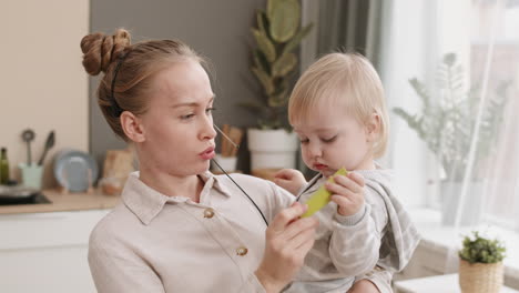 woman holding toddler and working