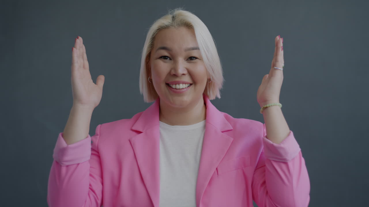 Woman in a pink blazer: Expressions of joy and surprise