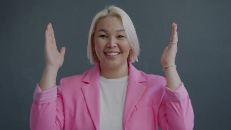 woman in a pink blazer: expressions of joy and surprise