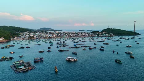 aerial view of phu quoc island, a fisher village with numerous fishing boats in the water and a cable car station visible on the horizon.the peaceful coastal lifestyle and marine activity, in vietnam.