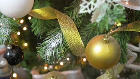 decorating christmas tree branches with fake snow spray for christmas and new year's eve